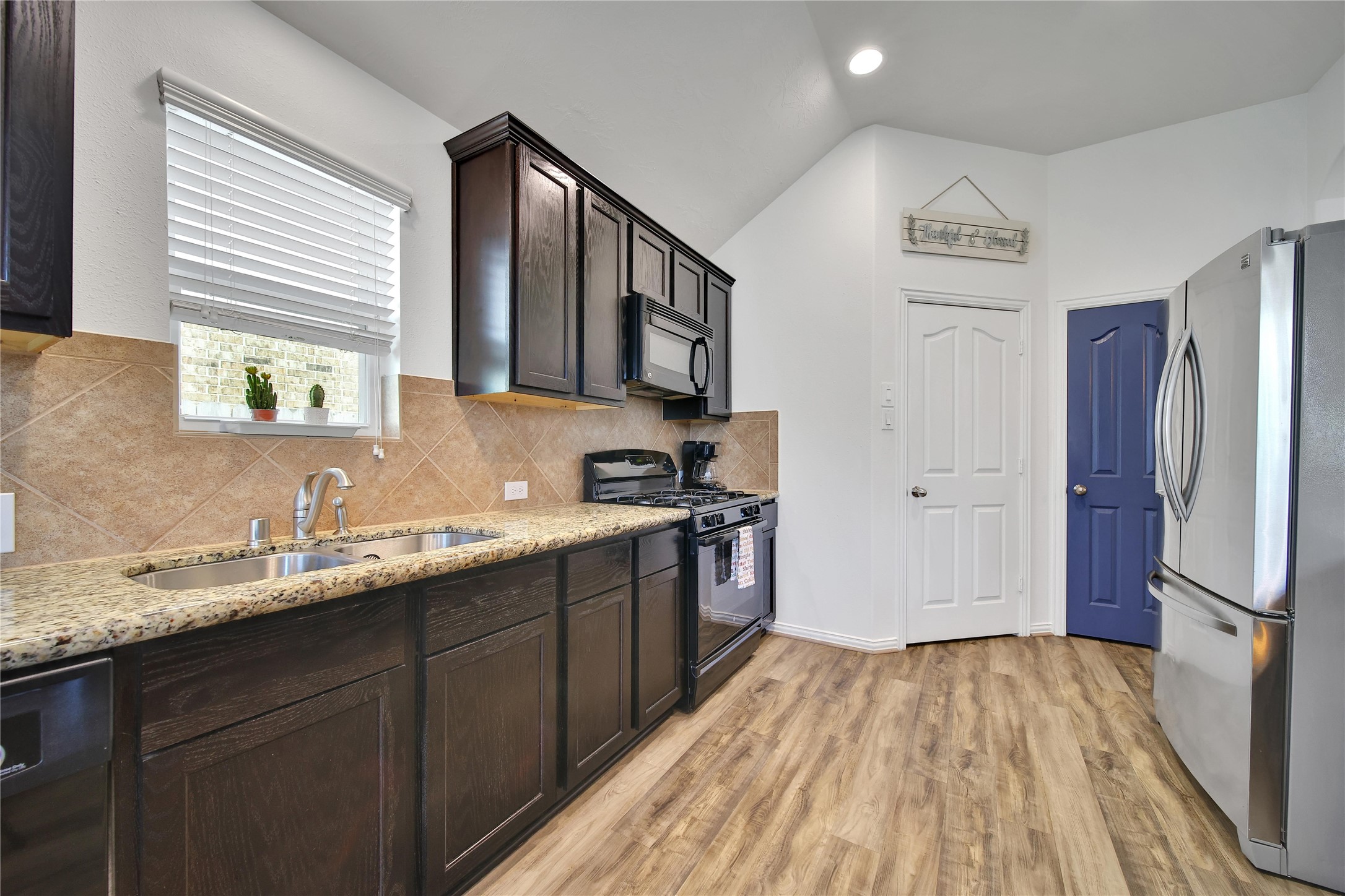 23411 Sawmill Pass Spring, TX 77373 - Photo 6 of 20 a kitchen with a sink stove and refrigerator