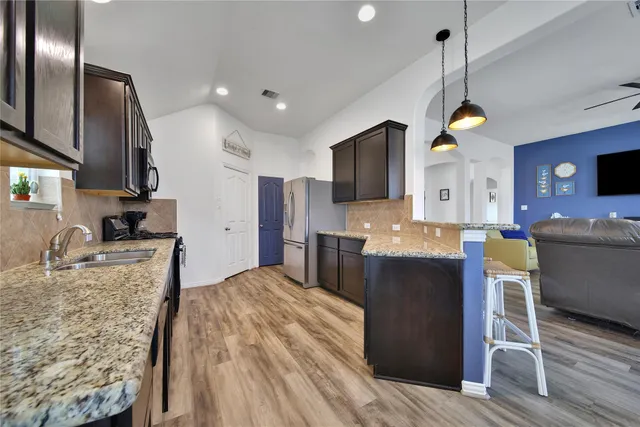 a living room with furniture a dining table and a fireplace
