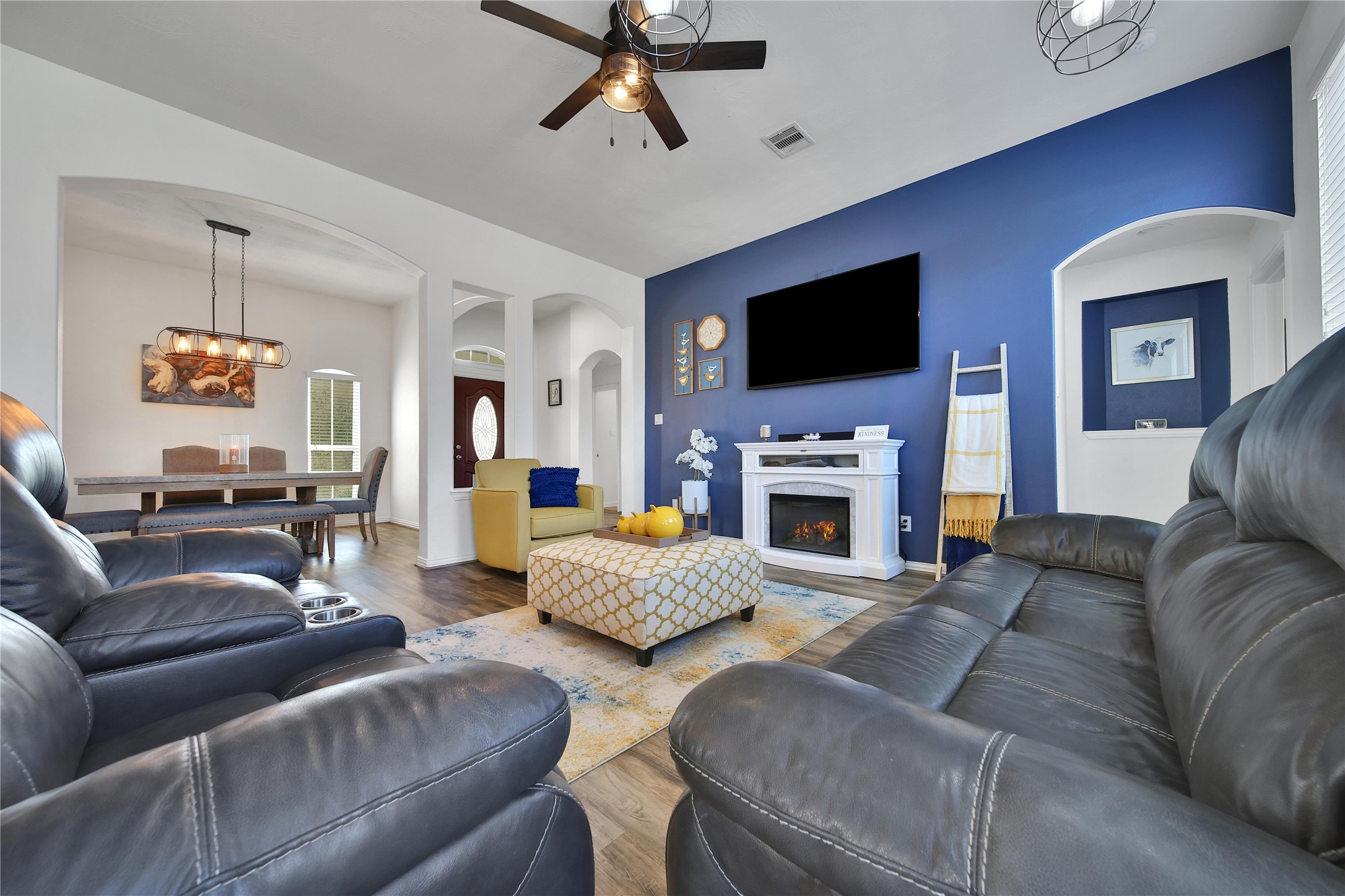 23411 Sawmill Pass Spring, TX 77373 - Photo 9 of 20 a living room with furniture a flat screen tv and a fireplace
