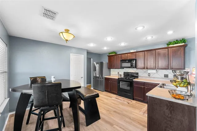 a kitchen with a table and chairs in it