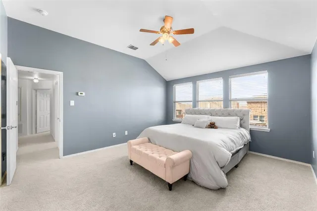 a bedroom with a bed chandelier and a window