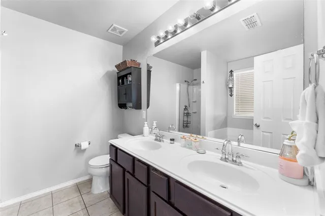 a bathroom with a double vanity sink and a mirror