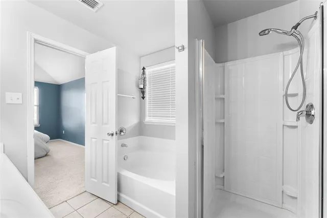 a bathroom with a bathtub and a shower