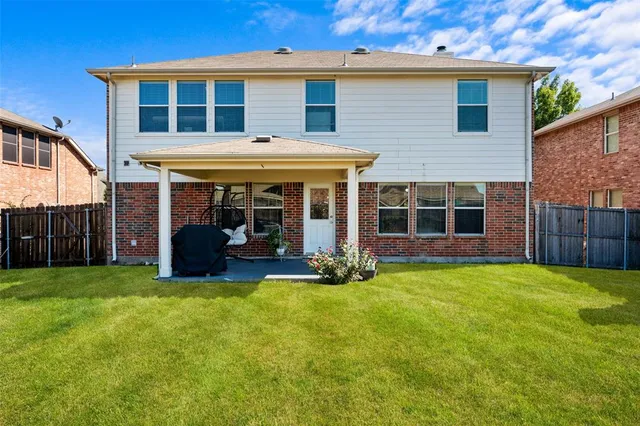 a view of a house with a yard and sitting area