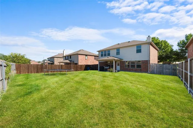 a front view of a house with a garden and deck