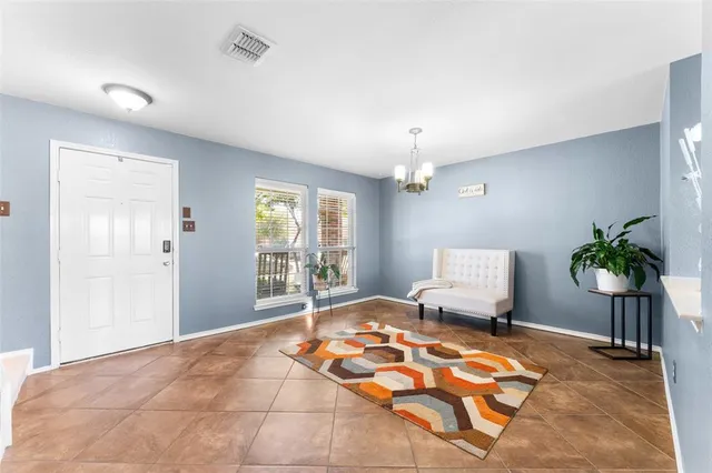 a bedroom with furniture and a chandelier