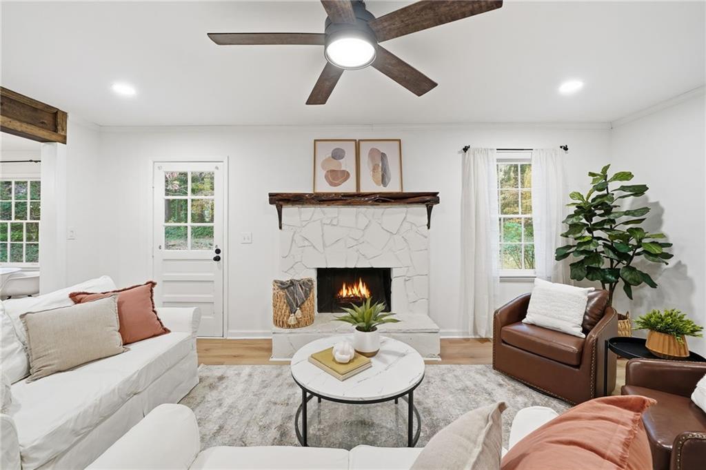 4422 Inlet Road Marietta, GA 30066 - Photo 1 of 1 a living room with furniture a fireplace and a large window