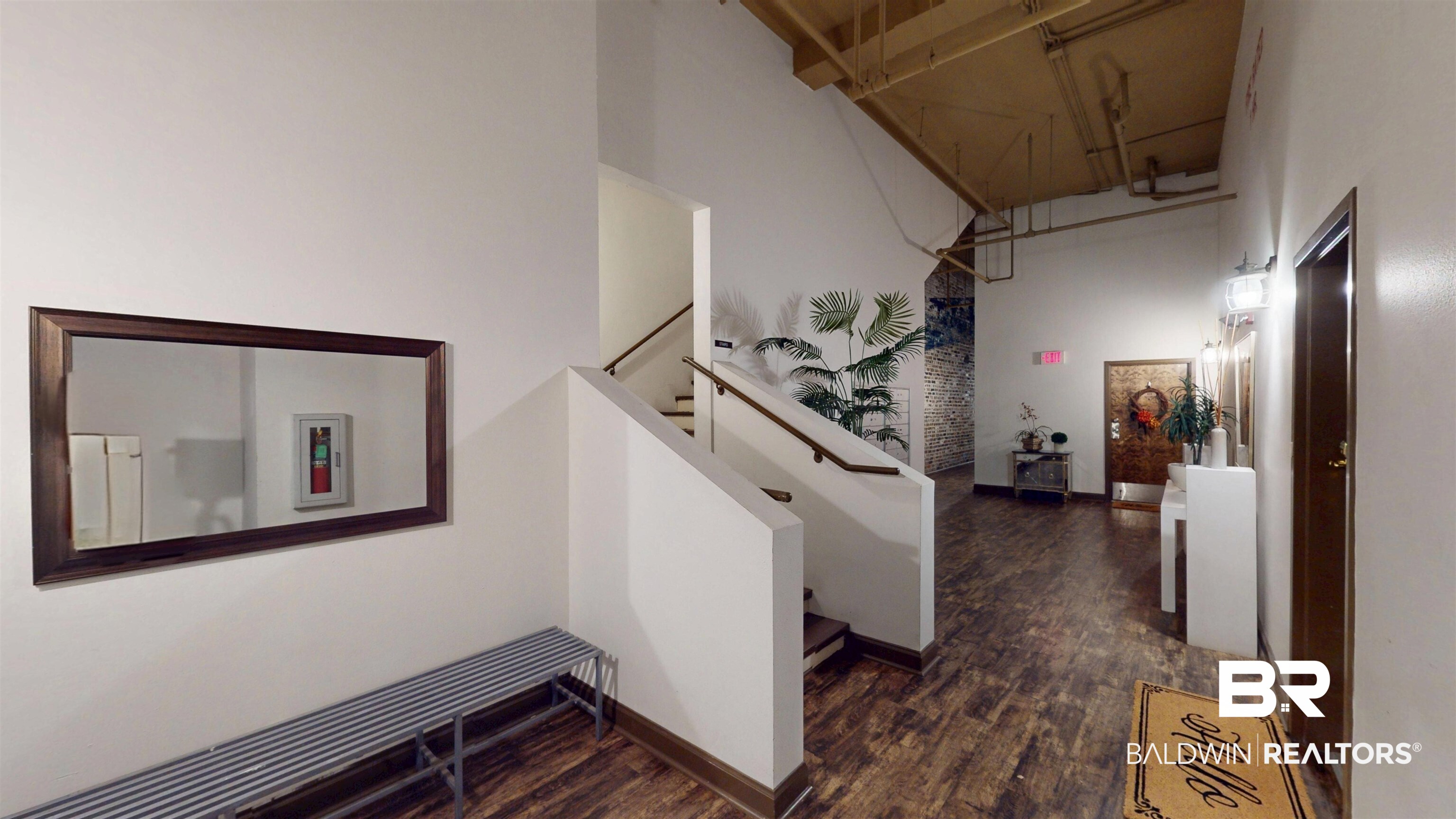 308 St Louis Street, Unit 101 Mobile, AL 36602 - Photo 14 of 30 Hall featuring a towering ceiling and dark wood-type flooring