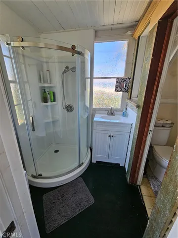 a bathroom with a shower and a sink