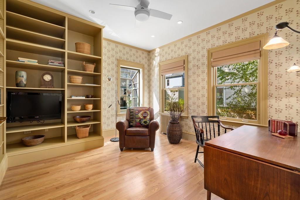 182 Upland Road Cambridge, MA 02140 - Photo 14 of 30 a living room with furniture a flat screen tv and floor to ceiling window