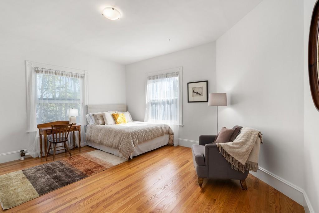 182 Upland Road Cambridge, MA 02140 - Photo 21 of 30 a bedroom with furniture and wooden floor