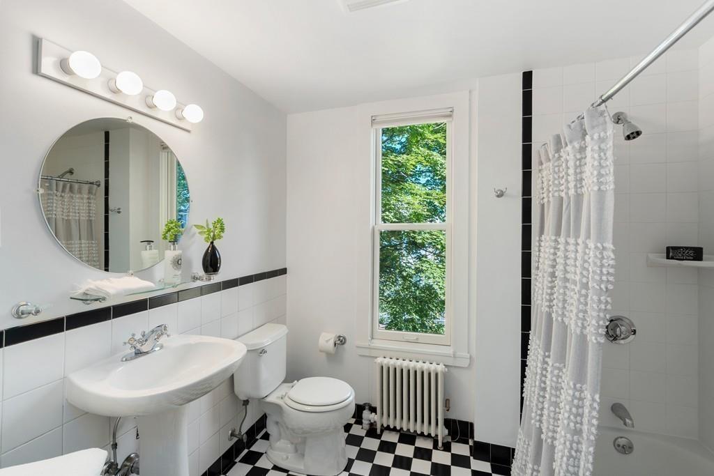 182 Upland Road Cambridge, MA 02140 - Photo 22 of 30 a bathroom with a sink toilet a mirror and shower