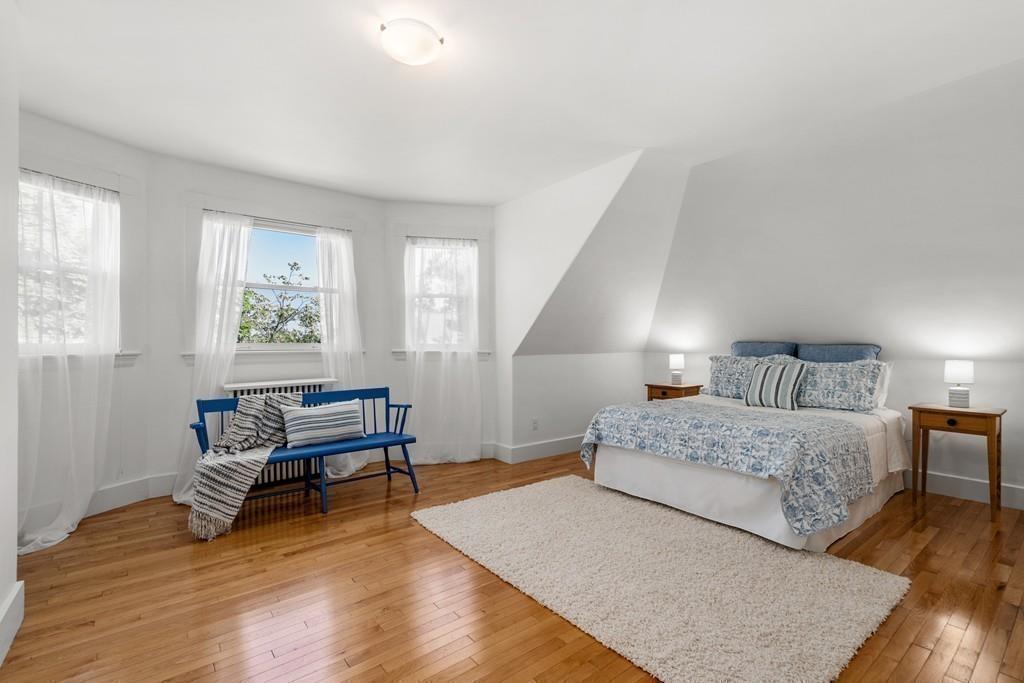 182 Upland Road Cambridge, MA 02140 - Photo 25 of 30 a bedroom with a bed furniture and wooden floor