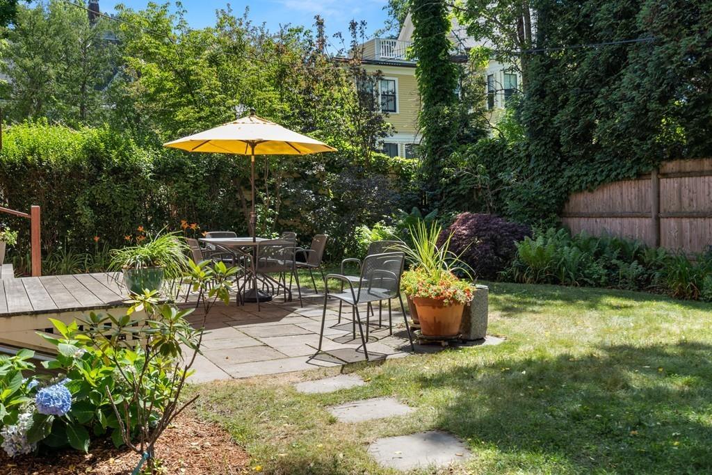 182 Upland Road Cambridge, MA 02140 - Photo 27 of 30 a backyard of a house with a swing table and chairs