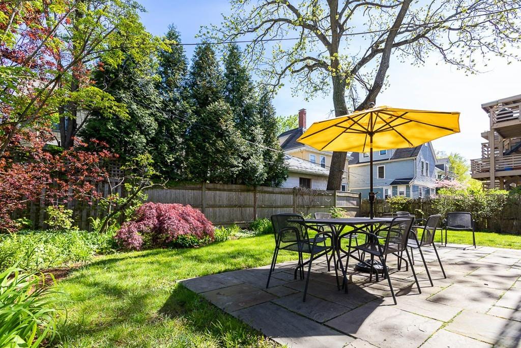 182 Upland Road Cambridge, MA 02140 - Photo 28 of 30 an outdoor space with furniture and umbrella