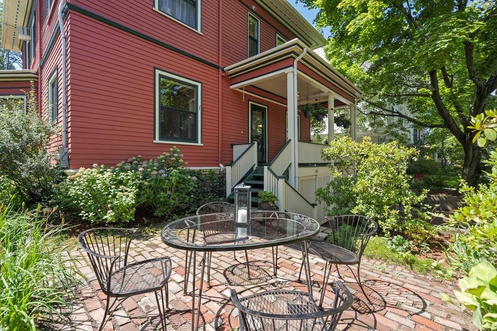 182 Upland Road Cambridge, MA 02140 - Photo 29 of 30 a backyard of a house with table and chairs