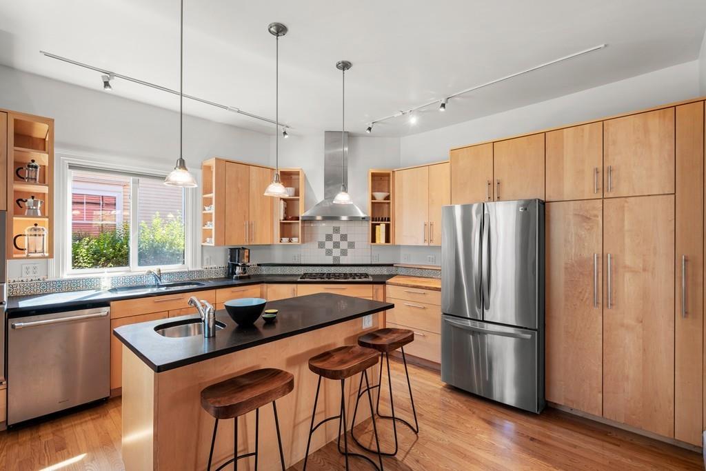 182 Upland Road Cambridge, MA 02140 - Photo 8 of 30 a kitchen with stainless steel appliances granite countertop a refrigerator a sink dishwasher a stove and a refrigerator with wooden floor
