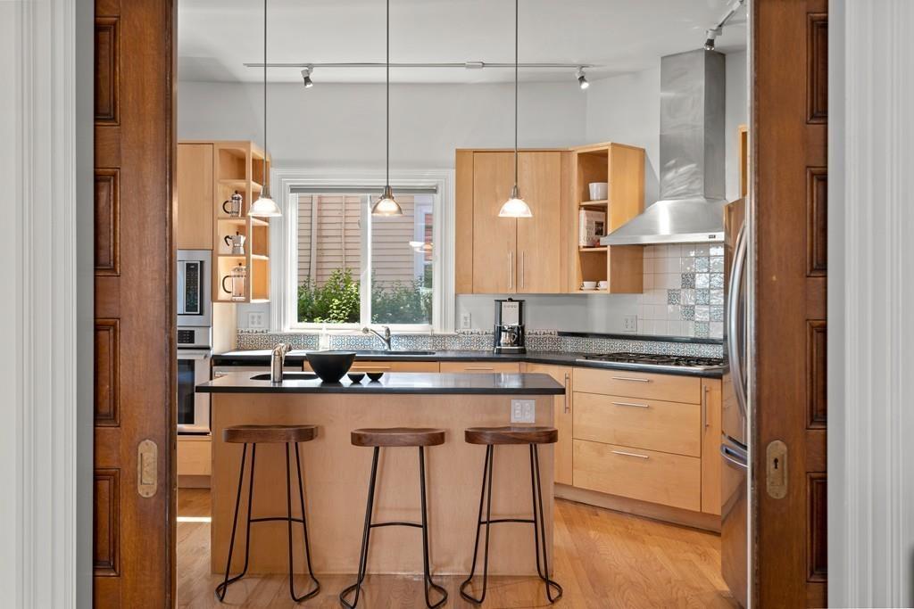 182 Upland Road Cambridge, MA 02140 - Photo 10 of 30 a kitchen with stainless steel appliances granite countertop a sink and a refrigerator