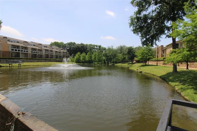 a view of a lake with houses in the back