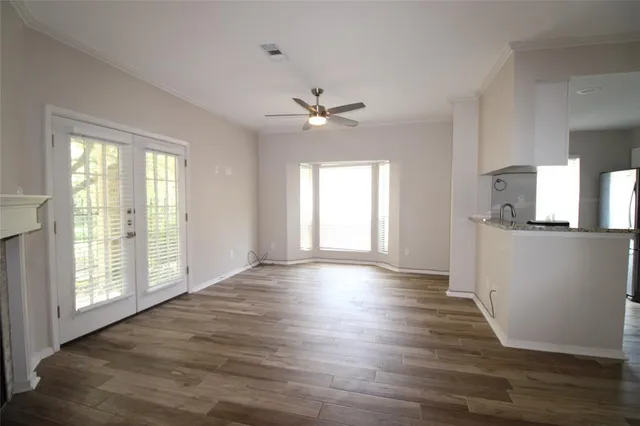 wooden floor in an empty room with a window
