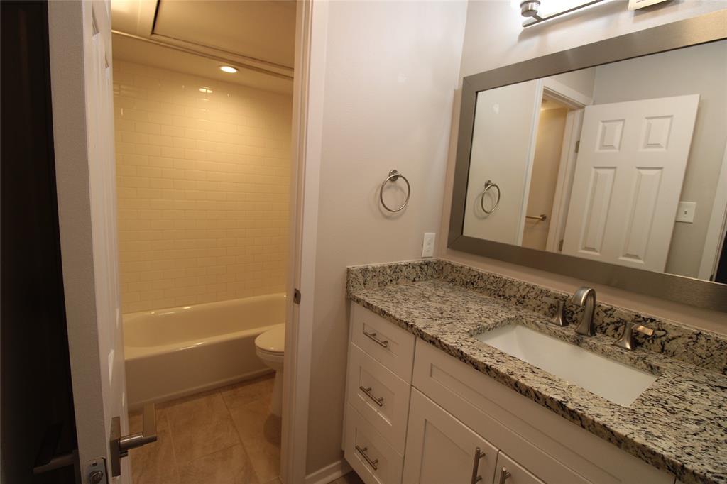 14333 Preston Road, Unit 1304 Dallas, TX 75254 - Photo 19 of 40 a bathroom with a granite countertop sink and a mirror
