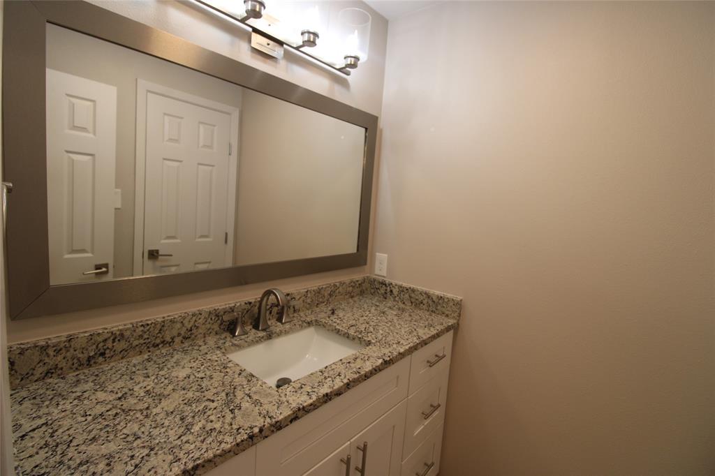 14333 Preston Road, Unit 1304 Dallas, TX 75254 - Photo 21 of 40 a bathroom with a granite countertop sink and a mirror