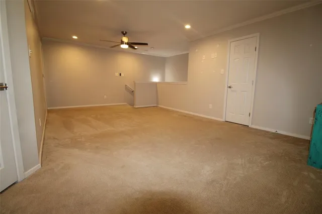 an empty room with a ceiling fan and a window