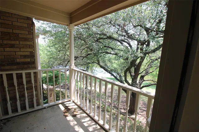 a view of a balcony with wooden floor
