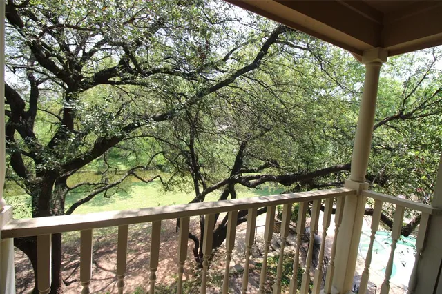 a wooden fence with trees in the back