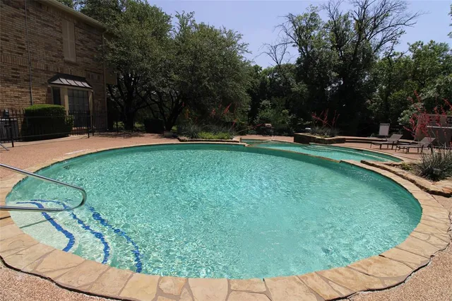 a swimming pool with outdoor seating and yard