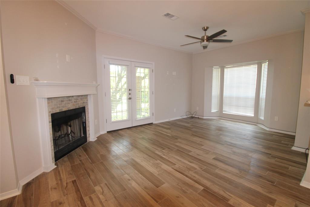 14333 Preston Road, Unit 1304 Dallas, TX 75254 - Photo 7 of 40 a view of empty room with wooden floor and fireplace