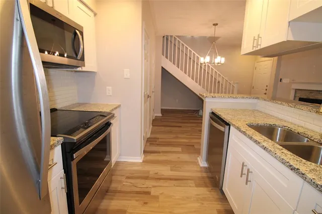 a kitchen with a sink and a microwave