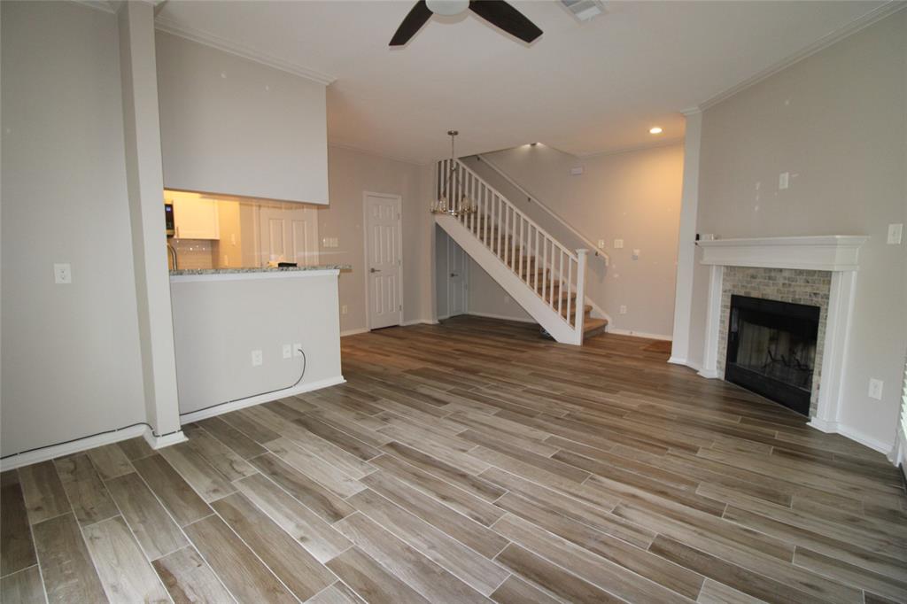 14333 Preston Road, Unit 1304 Dallas, TX 75254 - Photo 10 of 40 a view of an empty room with wooden floor a ceiling fan and a window