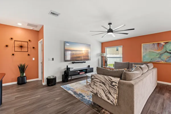 a living room with fireplace furniture and a wooden floor