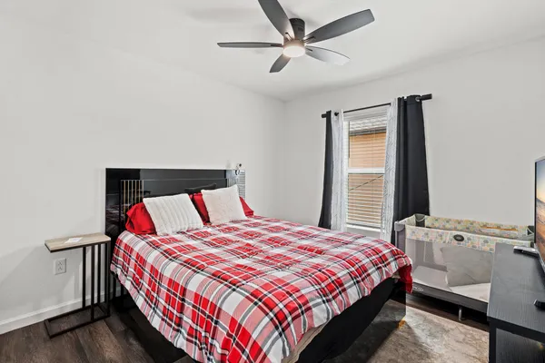 a bedroom with a bed dresser and a window