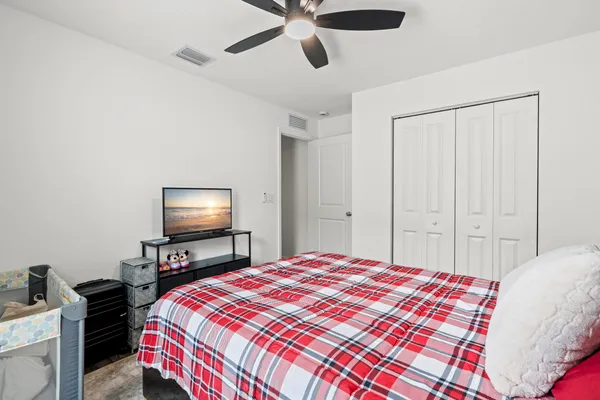 a bedroom with a bed and a flat screen tv