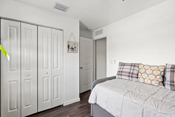 a bedroom with a bed and a chandelier