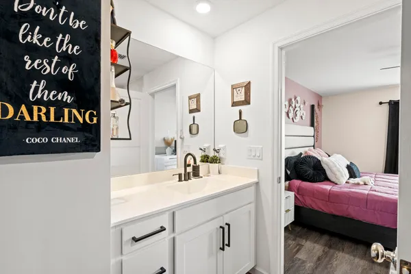 a bathroom with a sink a toilet and mirror
