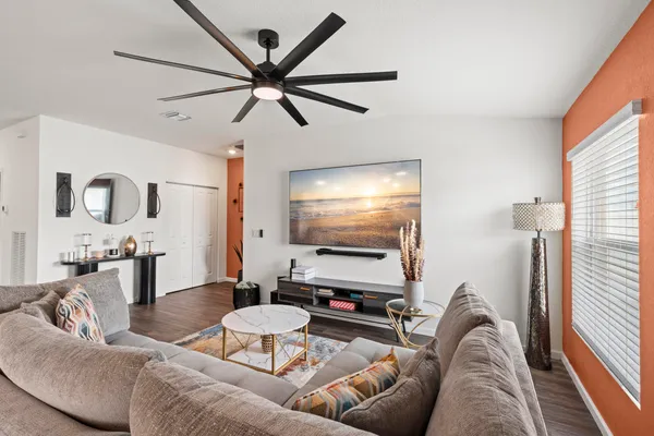 a living room with furniture and kitchen view