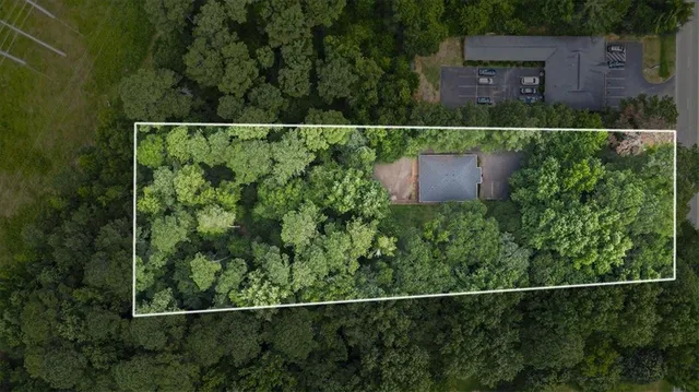 an aerial view of a house with a yard