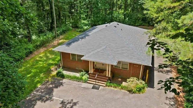 a view of backyard with swimming pool and trees in the background