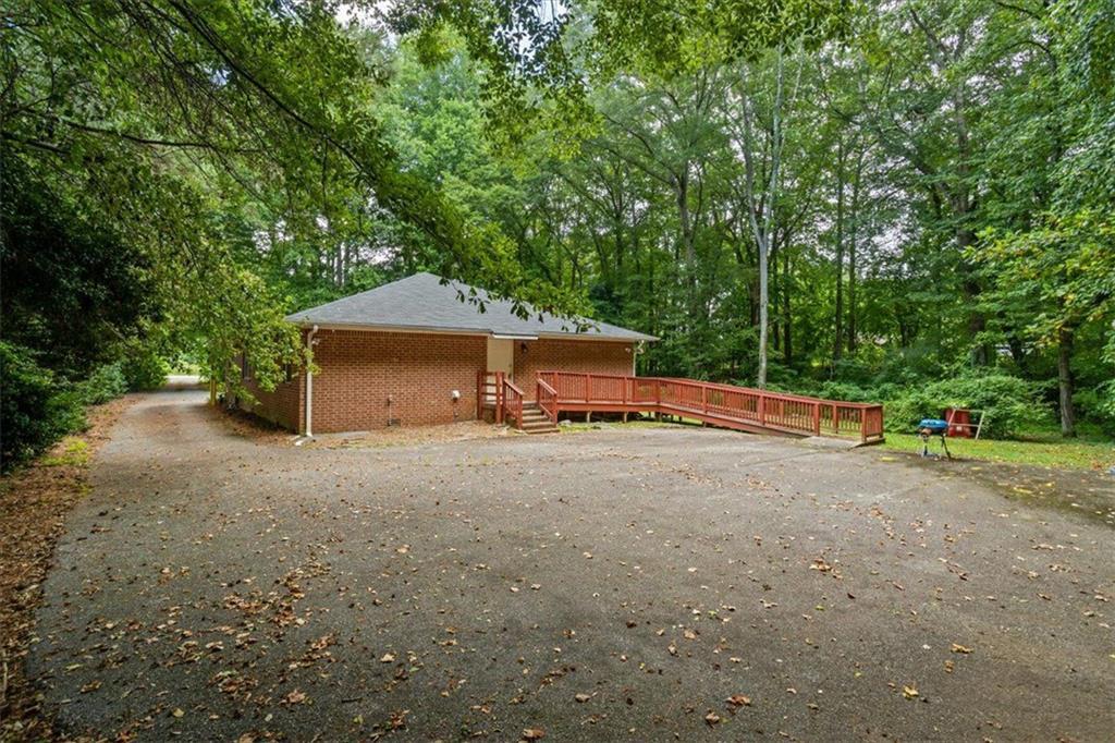 475 Newton Bridge Road Athens, GA 30607 - Photo 18 of 44 a backyard of a house with table and chairs under an umbrella
