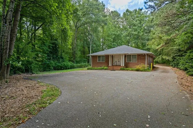 a front view of house with yard and green space