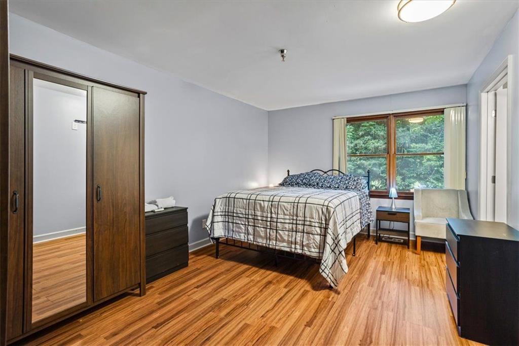 475 Newton Bridge Road Athens, GA 30607 - Photo 29 of 44 a bedroom with a bed and wooden floor