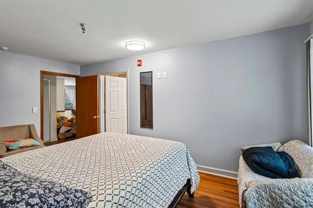 a bedroom with a bed and wooden floor