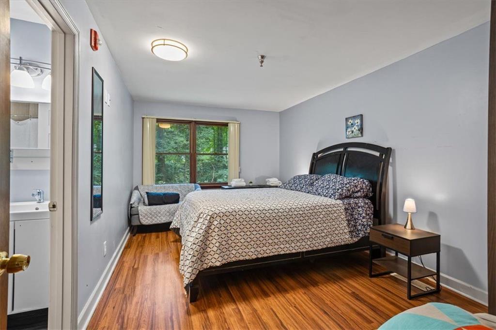 475 Newton Bridge Road Athens, GA 30607 - Photo 34 of 44 a bedroom with a bed and wooden floor