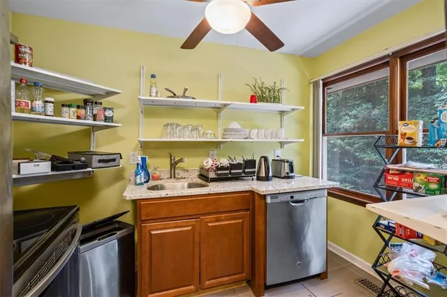 a kitchen with stainless steel appliances granite countertop a refrigerator and a stove