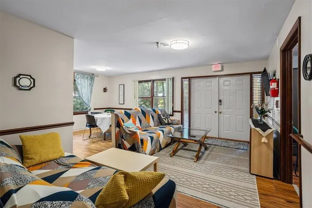 a group of people sitting on a floor in a kitchen