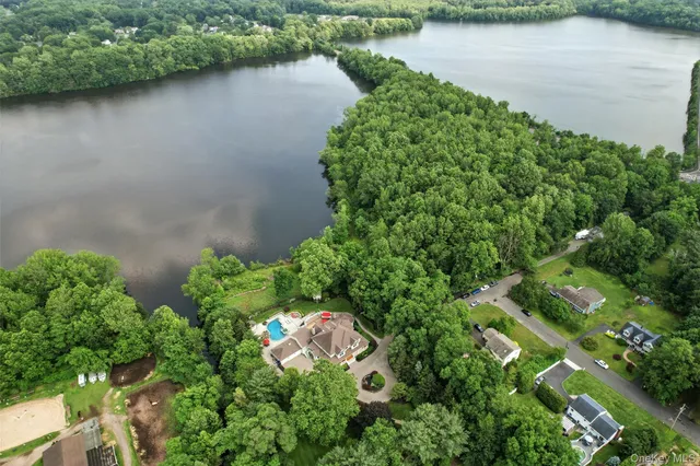 an aerial view of a house with a lake view