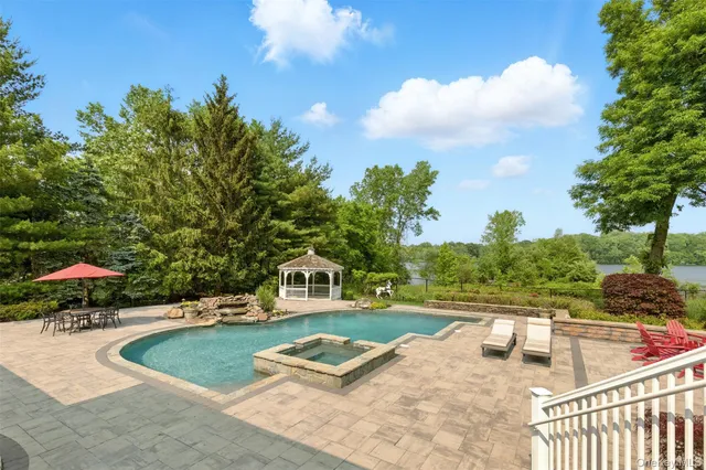 swimming pool view with a seating space